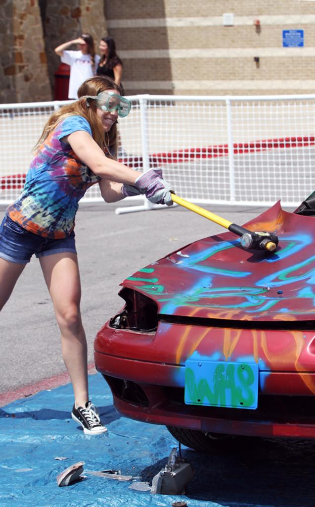 Freshman Colleen Pletcher releases some post-AP week tension as she takes part in the Teen Teaching sponsored event Car Bash on May 17.