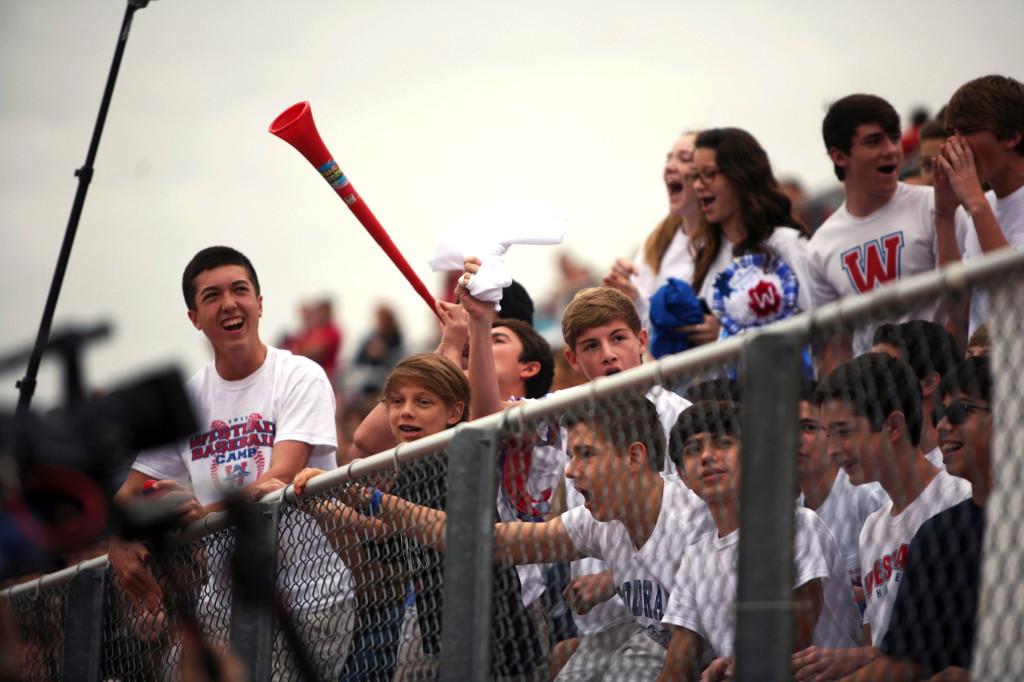 Students in the freshman section scream for the spirit stick to the tune of a vuvuzela.