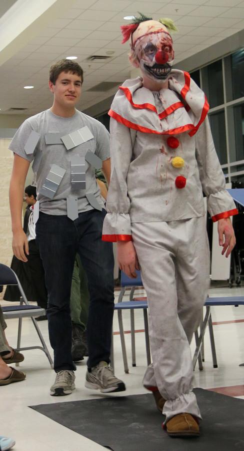 Senior Ben Gorr and freshman Sam Cardiganer presents their costumes during the Holloween orchestra concert on Oct.26.