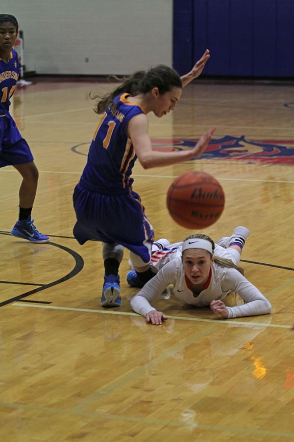 Senior Bailey Holle falls after trying to score a basket during the game against Anderson on Jan. 12.