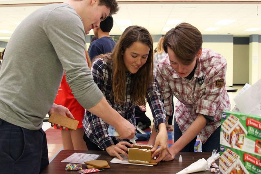 Students working together on their gingerbread house for the anual gingerbread house making compition in the commons on December 11, 2015.