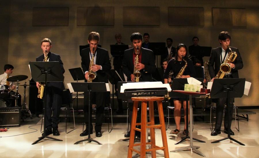 The saxophone section of freshman Ethan Lord, sophomore JD Carlton, junior Rohan Pilay, senior Michelle Hunter and junior Matthew Bundschuh stand and play their portion of an ensembles piece at the Spring Jazz Concert on Jan 21.