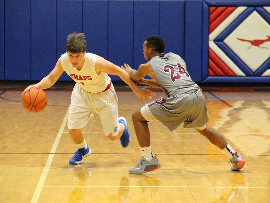 Westlake varsity player sweaps around his Austin High apponent, in search of a path to the basket.

by jake breedlove