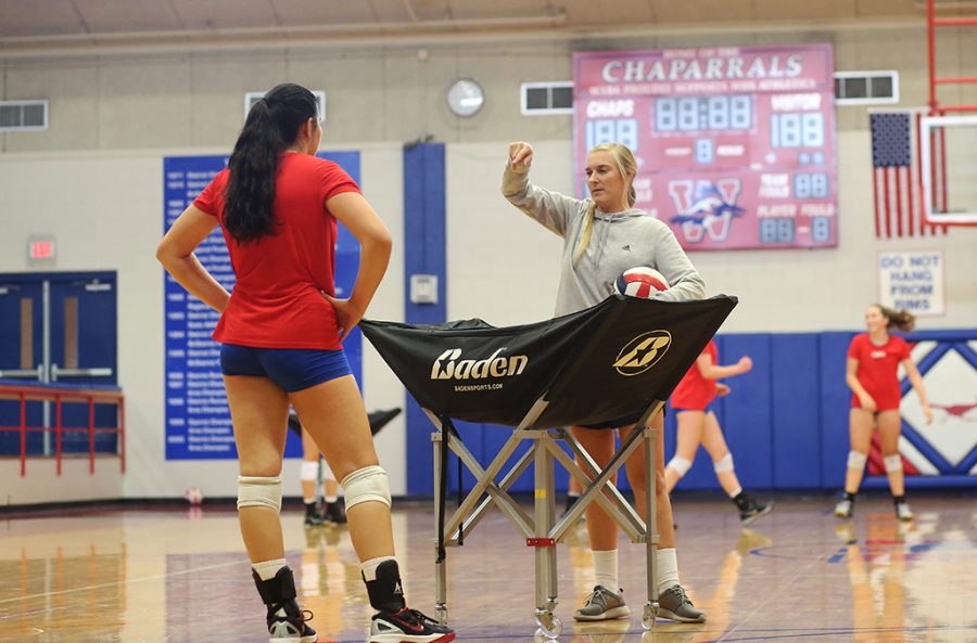 Senior Kassy Doering gets advice from one of the team coaches during a varsity team practice on Aug. 29.