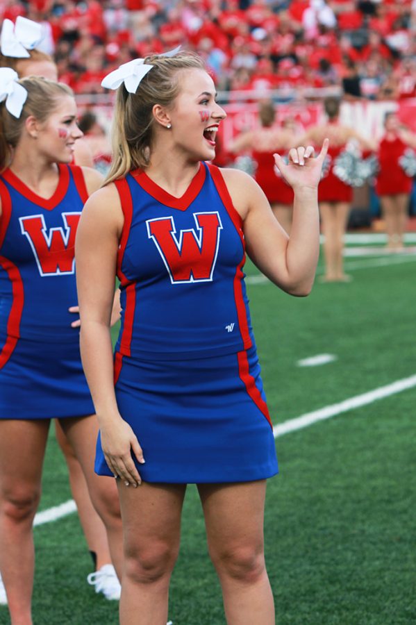 Sarah Grace Peterson puts up a chap while the Westlake varsity football team warmed up for their game against Katy. on Aug 26.