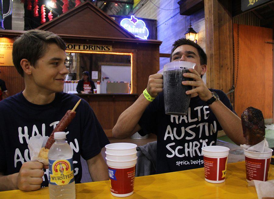 Chugging a gallon of soda, juniors Aaron Babineau and James Perdue laugh while enjoying a day at the annual Wurstfest on Nov. 9. German students from Westlake take a day off from school and go to the student day Wurstfest every year.