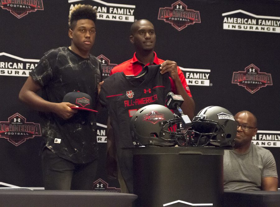 Senior Levi Jones getting his all american jersey and hat during a press conference to announce his participation.