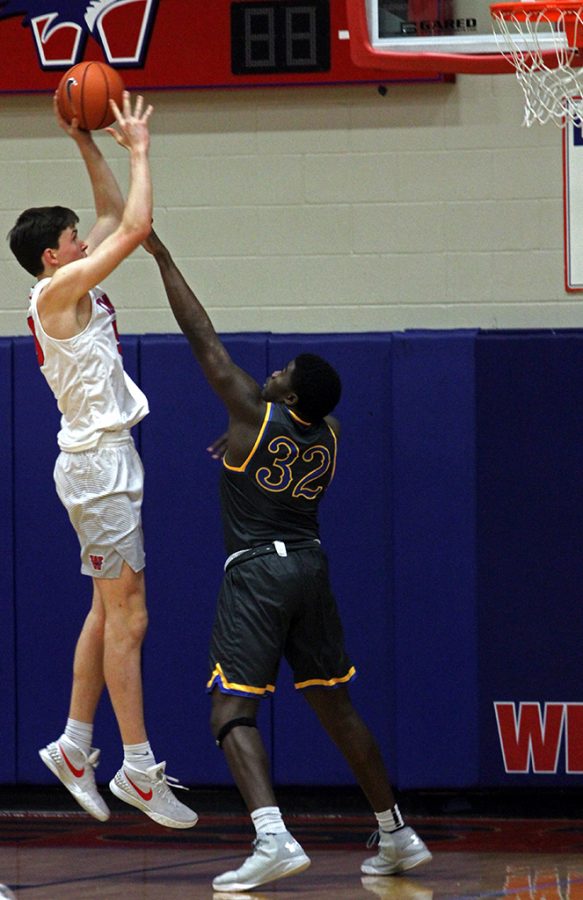 Sophomore Will Baker tries to get a shot past Anderson.