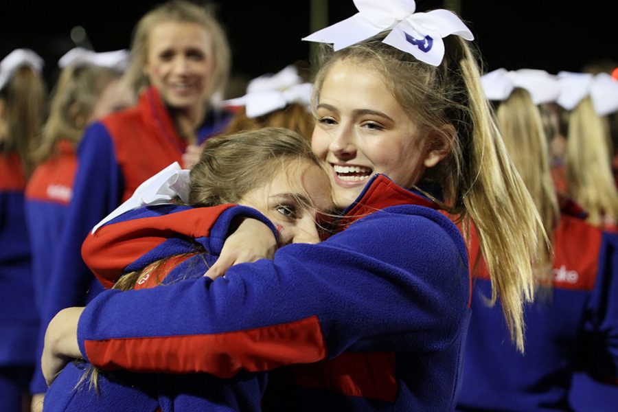 Freshman Kennedy Griebel hugs another cheerleader after Westlake beats Judson in a playoff game on Nov. 19.