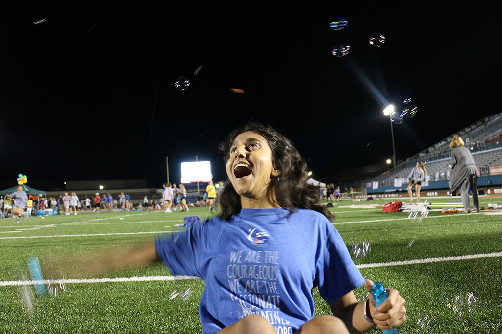 Student volunteer junior Ivany Patel waves a bubble stick around late into the night during Westlakes Relay For Life.