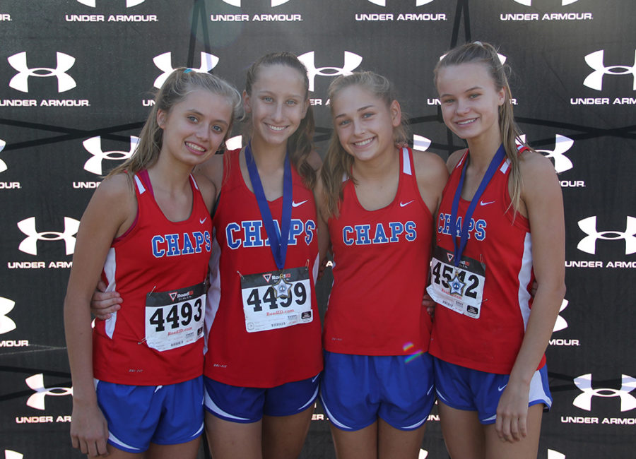 Freshman Cassidy Beard and sophmores Maddie Dawson, Kasey Hedrix and Elise Smoot pose after Maddie and Elise get top 15 in a recent varsity crosscountry race.