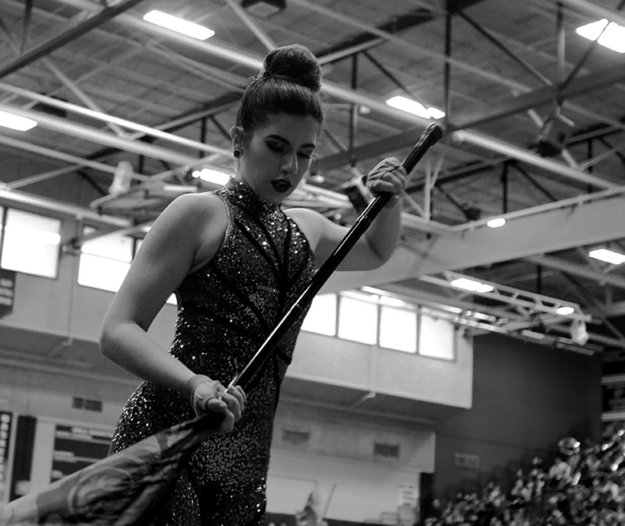 Junior Hannah Mickelson performs with the Color Guard at the Feb 22nd pep rally. Their rendition of Old Keys excited the crowd and left them anxious for what was next.