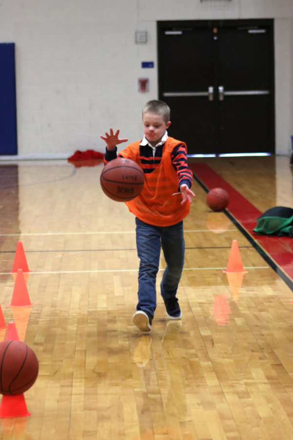 Focusing on dribbling, Christopher Ardi races back to the start line. The special olympics took place in the Ninth Grade center gym.