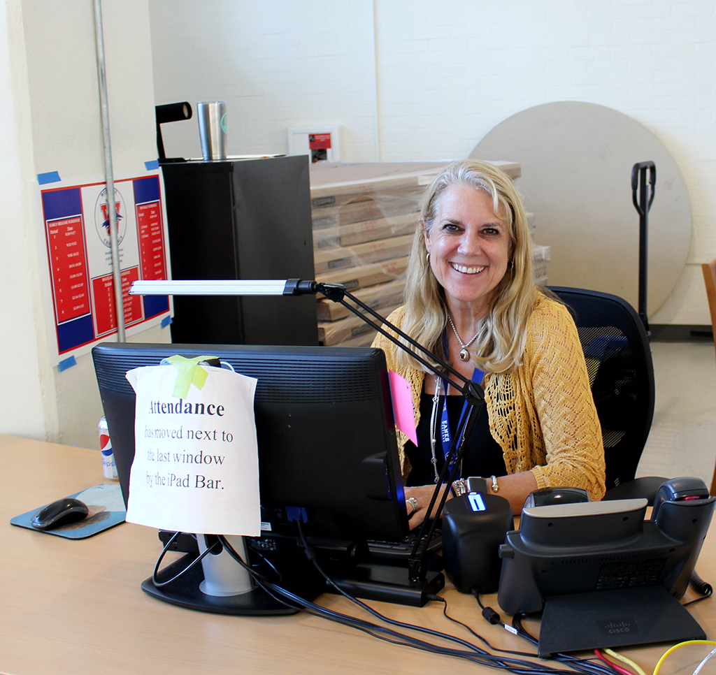 Receptionist Karen Lear at her station in the Chap Court. Lear is in charge of regulating the buzz-in system, one of the new security improvements.