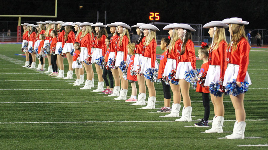 Hyline includes elementary girls in welcoming Westlake football players in the Hays game on October 26.