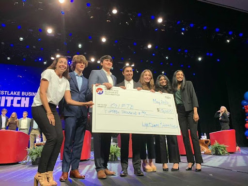 Team mentor Katina Kenyon and seniors Leo Weihe, Amir Alaghehband, Jash Desai, Emily Weiner, Nina Velacheri and Radhika Gautam (left to right) display their winnings from the Business INCubator Pitch Night May 20. The GiftE team received $15,000 from Pitch Night and recently won the National Pitch competition, receiving an additional $10,000. 