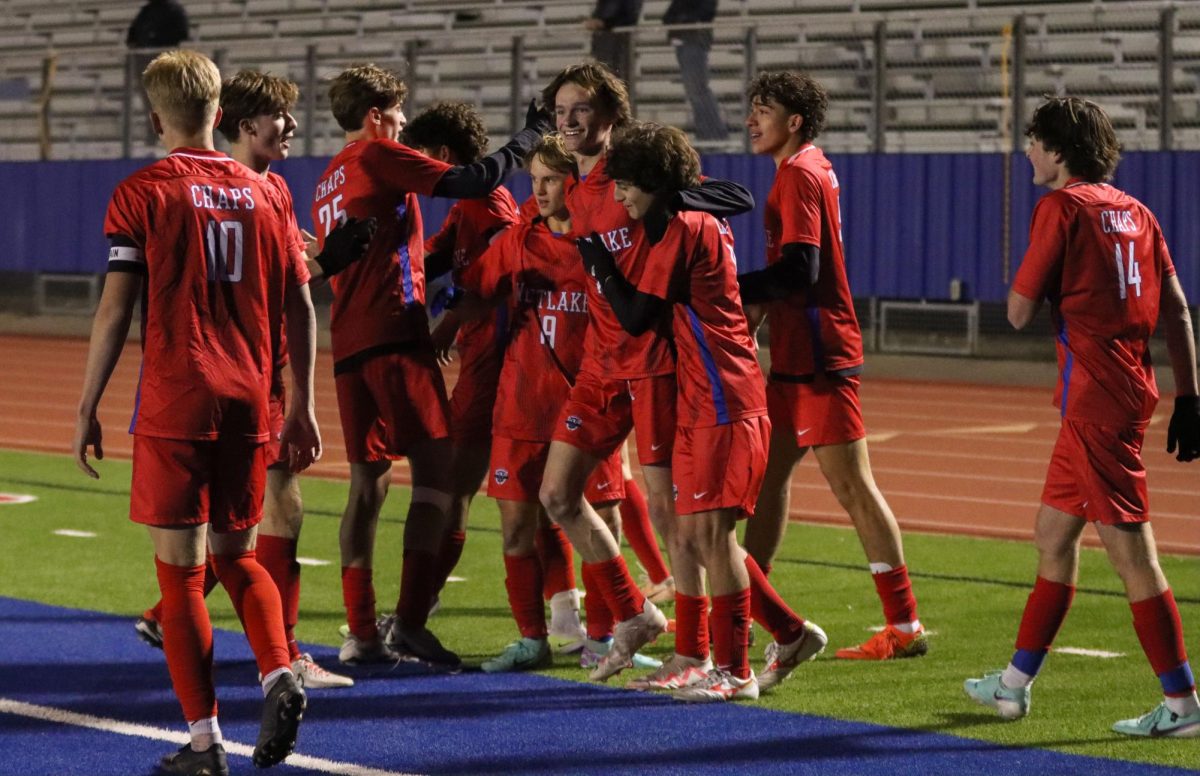Chaps+celebrate+a+goal+in+the+first+half+of+their+3-0+win+over+Lake+Travis+Wednesday.+The+win+helps+the+Chaps+maintain+an+undefeated+record+as+they+begin+district+play.++