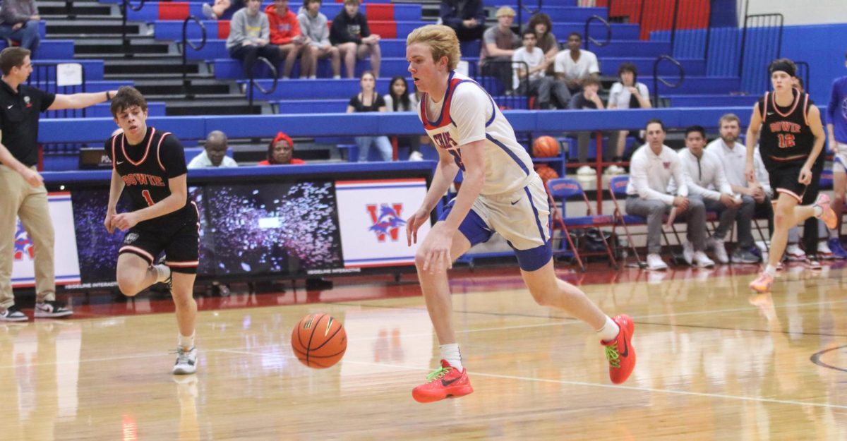 Forward junior Jack Seiders dribbles on a fast break in the first quarter of the Chaps win Friday. Seiders had eight points in the contest. 