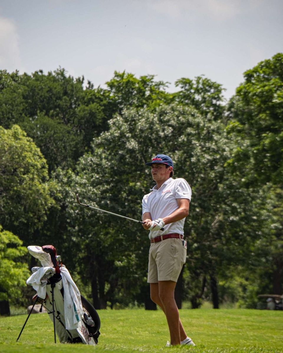 Senior Blake Burt follows through on a huge drive at the UIL 6A boys state golf tournament at White Wing Golf Club April 29. Burt shot five over on the first day but recovered on the second day by shooting even.