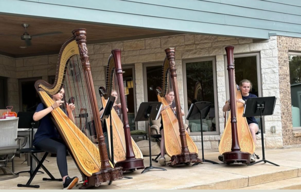 Freshmen Amber Hoffman and Catherine Browne and sophomores Caroline Leath and Sabrina Sprangle play Brahms Waltz No. 2 at Harpeque Wednesday, May 22. Along with ensemble pieces, harpists from the middle schools and high school played solos and duets.