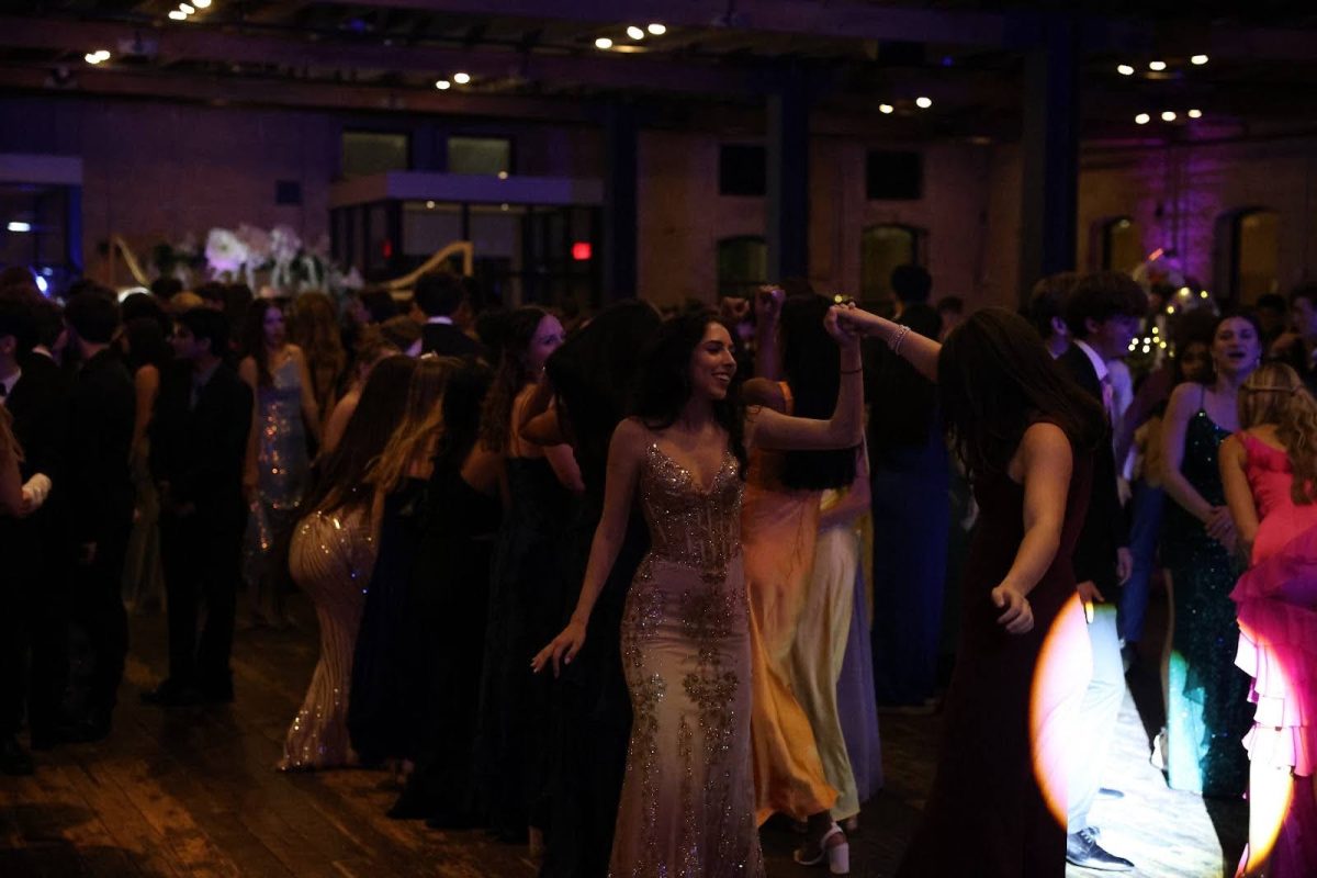 Students dance to the music and talents of DJ JMC at Brazos Hall April 27. They danced as they celebrated the end of the year’s festivities, with this being the first off-campus prom in years. 