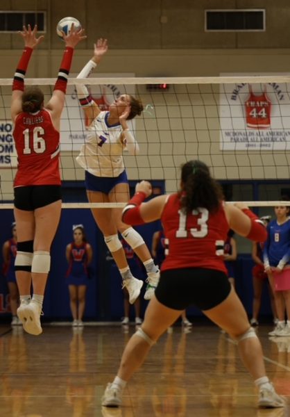 Outside hitter senior Lily Davis spikes the ball in the Chaps’ 3-0 win against Lake Travis Oct. 1.