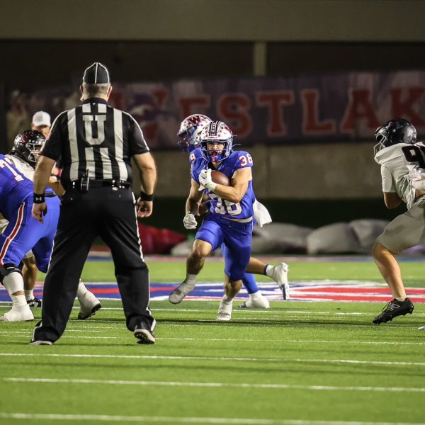 Senior running back Grady Bartlett rushes for a first down against Bowie at Chaparral Stadium Oct. 18. The Chaps out-rushed the Bulldogs by 202 yards. 