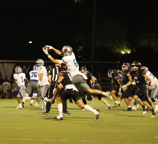 Senior wide receiver Brody Wilhelm reaches for a reception against Austin High Oct. 10. Wilhelm reeled in four catches for 70 yards and two touchdowns.