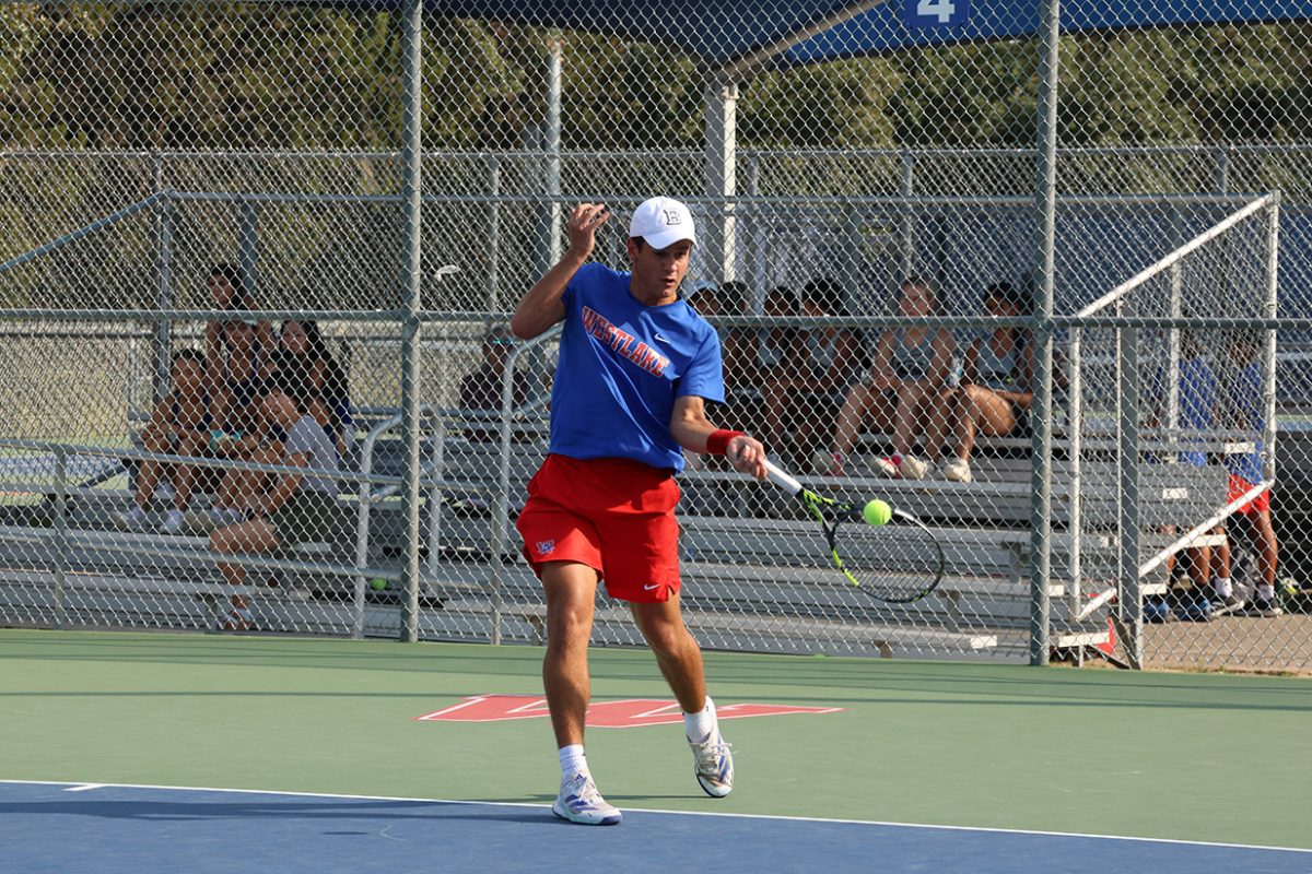 As he connects with the ball, senior Luke Riezebeek competes in the Bi-District match against Round Rock Oct. 7. 