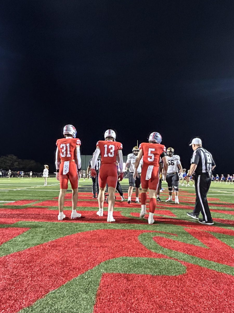 Senior Linebacker Elliot Schaper, Senior Defensive End Connor Vasek and Senior Safety Peyton Luther stand during the coin flip agianst Breannan 11/22/24 at Burger Stadium.