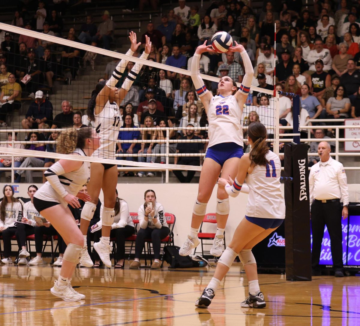 Freshman setter Clayton Kelly jumps to set the ball against Johnson at the Burger Gym Nov. 14. The Chaps moved on to the state semifinals for the first time in 15 years. 