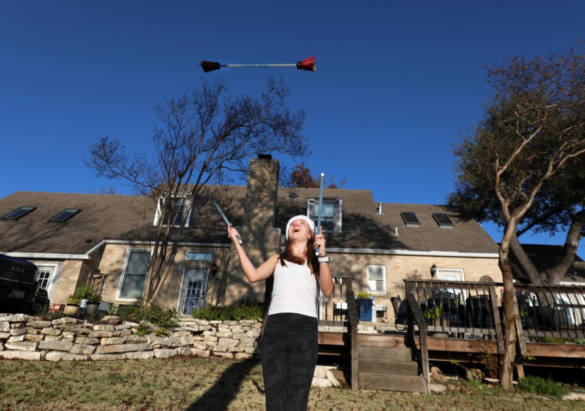 Junior Lexie Tilson performs her flower sticks to ad to her anual Stixmas Dec. 18 in her backyard. Tilson completed her 2024 Stixmas and will continue her performances in the 2025 Christmas season. 