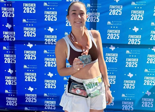 Junior Nya Seals poses with her medal after completing a full marathon.