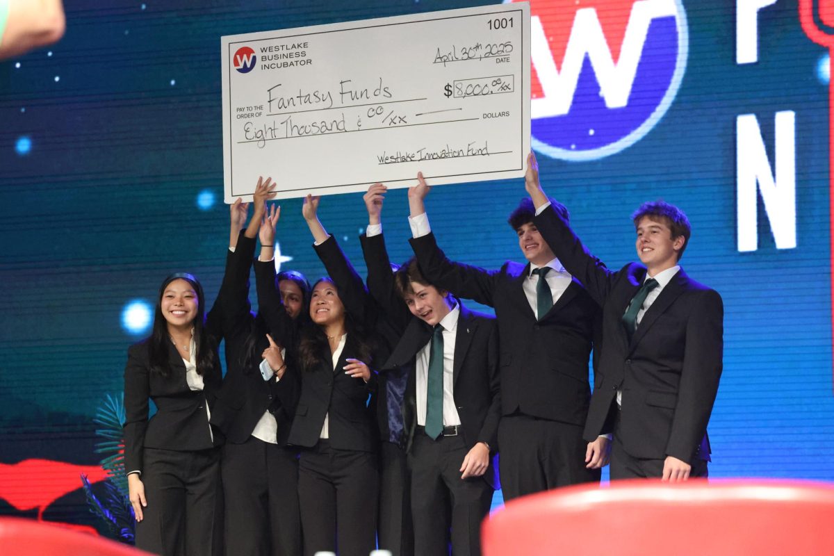As they raise their $8,000 check above their heads, the Fantasy Funds team accepts second place April 30 at pitch night. Fantasy Funds, a wild card team, walked away with an investment to further their plan for an app to gamify financial literacy.