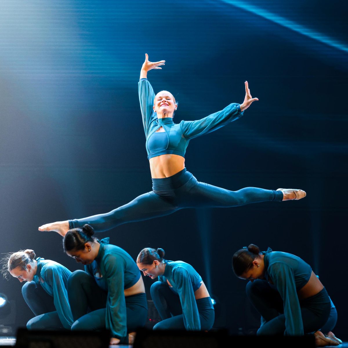 First lieutenant senior Lilly Dennis leaps through the air at a Zenith rehearsal April 22.