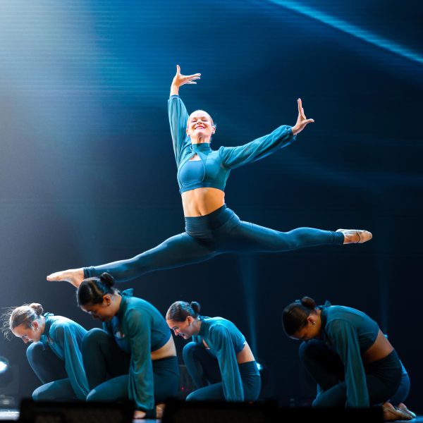 First lieutenant senior Lilly Dennis leaps through the air at a Zenith rehearsal April 22.