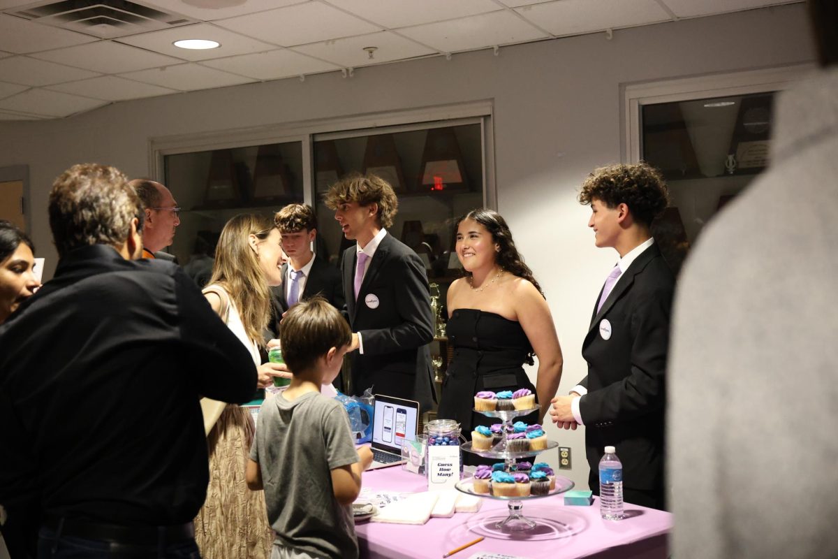 Working together to secure votes, juniors Jesse Ramos, Allie Khan and Ian Dumitrescu pitch their idea: Live Eyes. “Being a part of Team Live Eyes has been a great experience,” Ramos said. “It’s been awesome to get to know and become close with my group.”