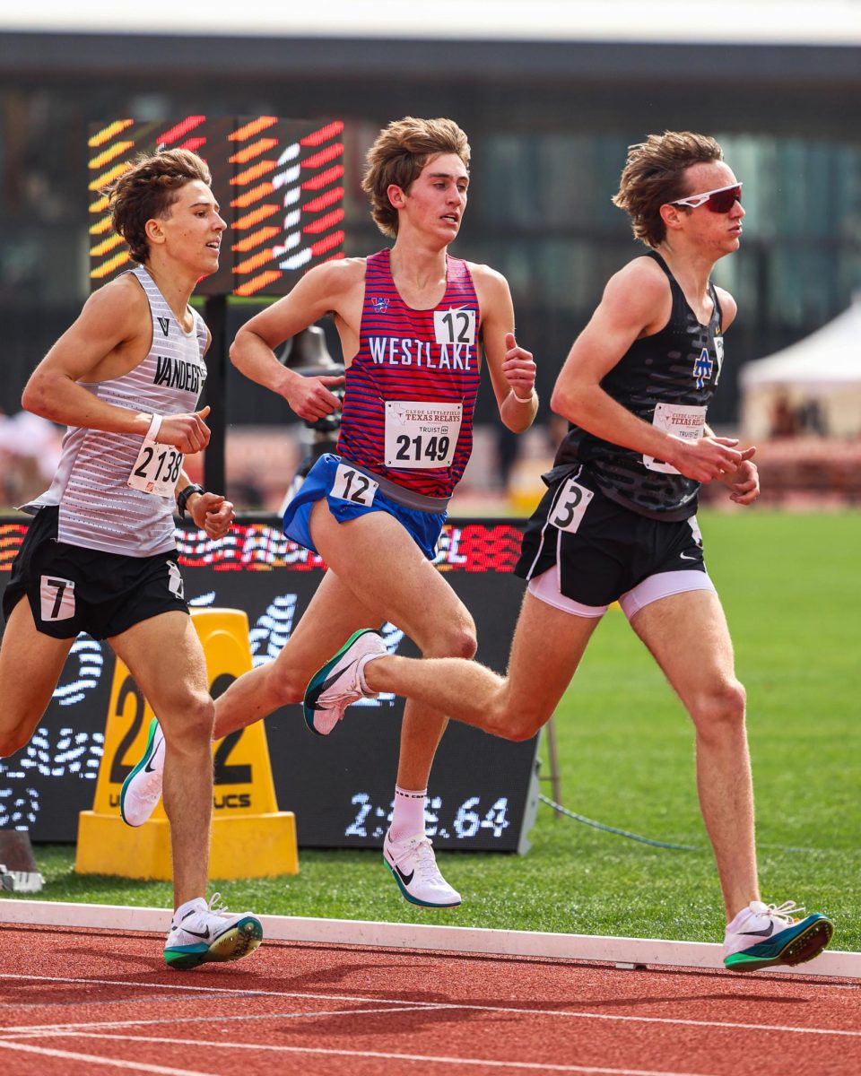 Keeping his pace in the 1600 m, junior Grant Seade competes in the Texas Relays March 29. Seade finished with a time of 4:14.88, just hundredths of a second shy of the school record of 4:14.69.