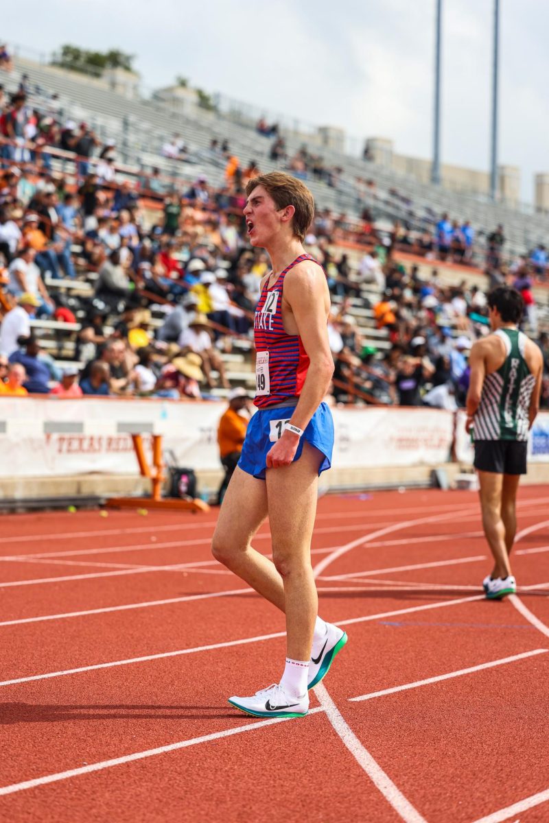 Celebrating his finish in the 1600m, junior Grant Seade placed fifth at the 97th Clyde Littlefield Texas Relays March 29. Seade finished with a time of 4:14.88, just hundredths of a second shy of the school record of 4:14.69.