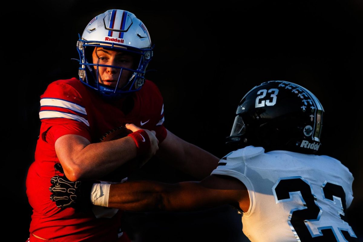 Senior quarterback Rees Wise carries the ball past a tackle attempt from the Steele defense in the first half of the Westlake Chaparrals victory over the Steele Knights at Chaparral Stadium Sept. 19. (Joe Nogalski/Westlake Featherduster)