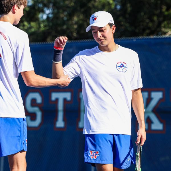 Senior Oliver Garcia prepares for his match against Bowie with a handshake Sept. 26 at Westlake High School. Garcia and his doubles partner prevailed 6-3, 6-1. 