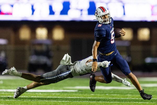 A Chaparral defender tries to wrap up Atascocita junior quarterback Isaiah Rasheed in the backfield Sept. 12 at George Turner Stadium. The Westlake defense collected six sacks en route to a 35-28 win. 