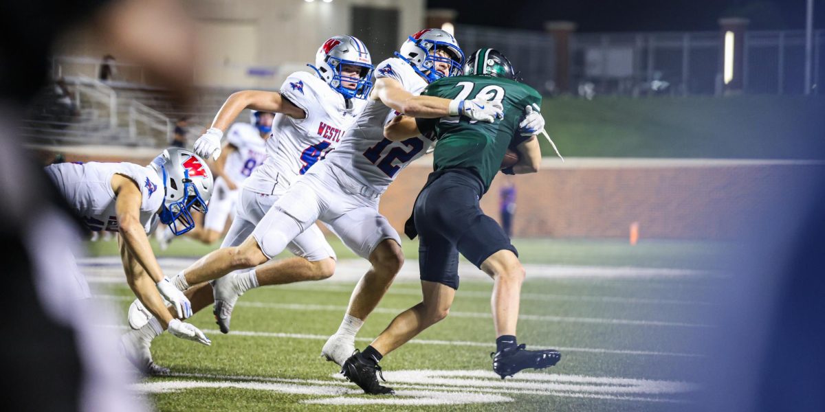 Sweat flying in the air, defensive back senior Hayes Brodhead tackles a Prosper wide receiver in Westlake’s season opener Aug. 29. The Chaps lost 22-29. 