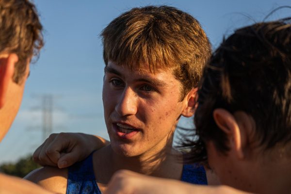 Senior Grant Seade talks to the Boys Varsity Team prior to the District 26-6A Meet at Walter E. Long Metropolitan Park Oct. 7.