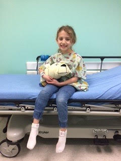The author sitting on a Dell Children’s hospital bed.