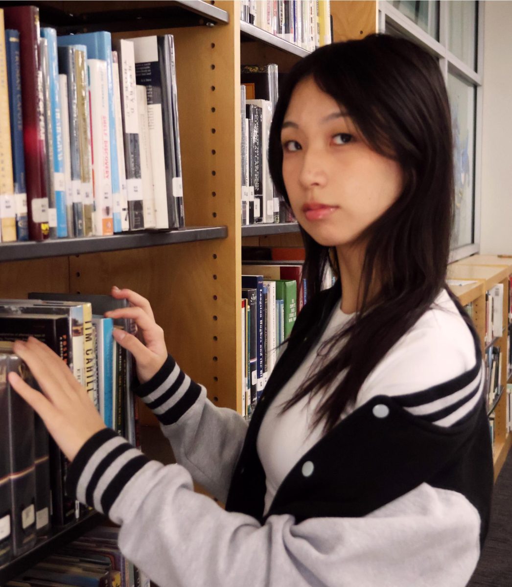 Senior Audrey Han spends time in the poetry section of the WHS library Nov. 12. Han writes prose, short stories, novellas and poetry. 