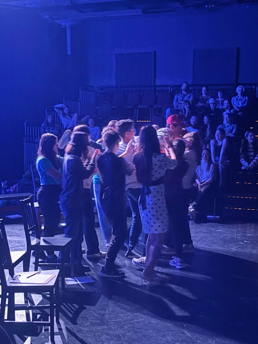 Emmett is carried by castmates mid-monologue in “Aftermath.”