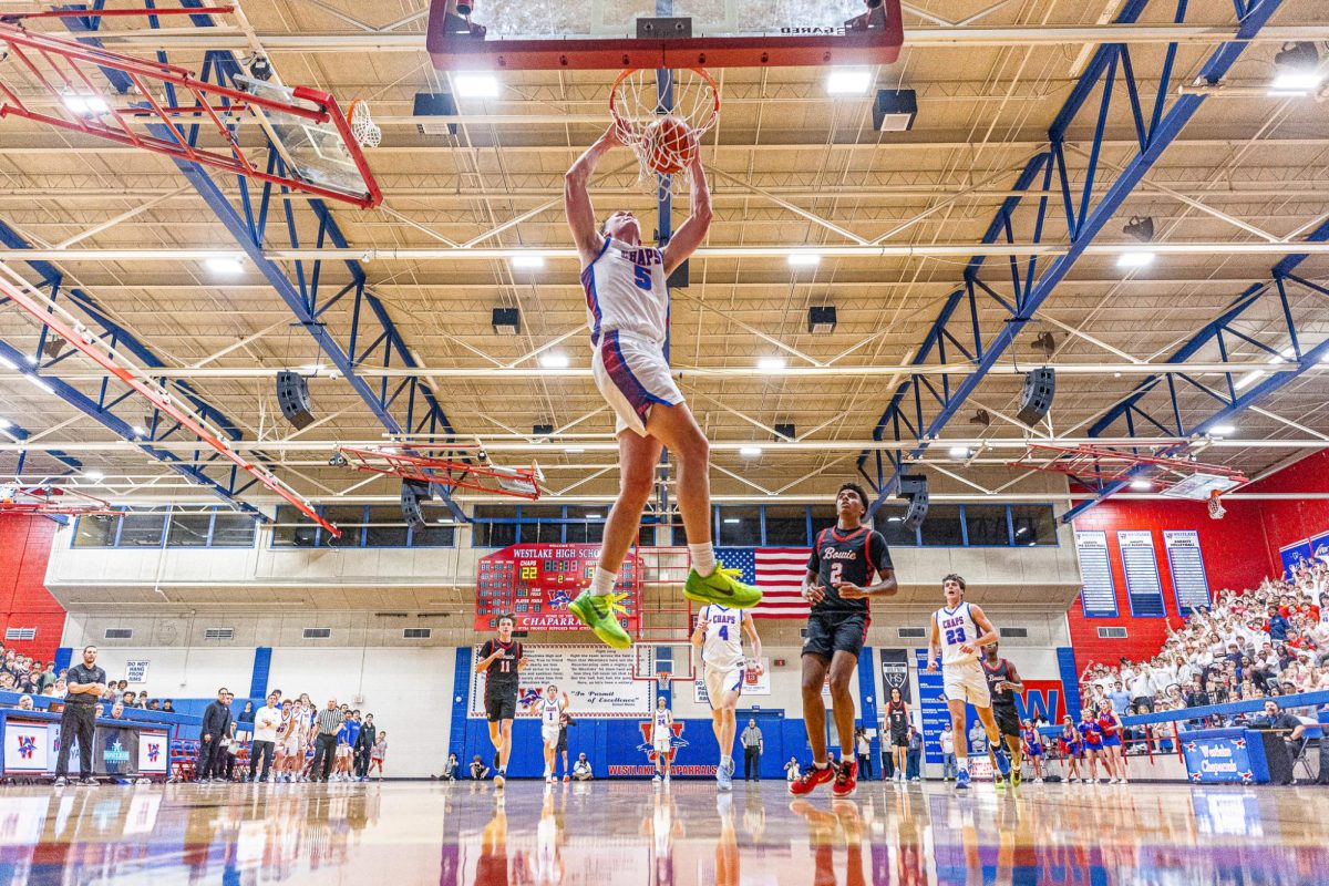 Senior forward Bo Ogden slams down a dunk during the game between the Westlake Chaparrals and Bowie Bulldogs at Al Bennet Court, Jan. 6, 2025.