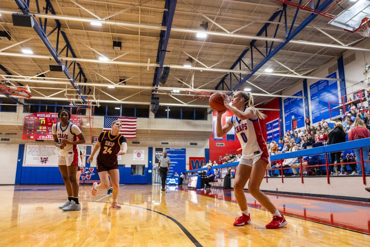 Junior guard Molly Frazer shoots a three pointer during their 71-32 win against Dripping Springs Jan. 13 at Al Bennett Court.