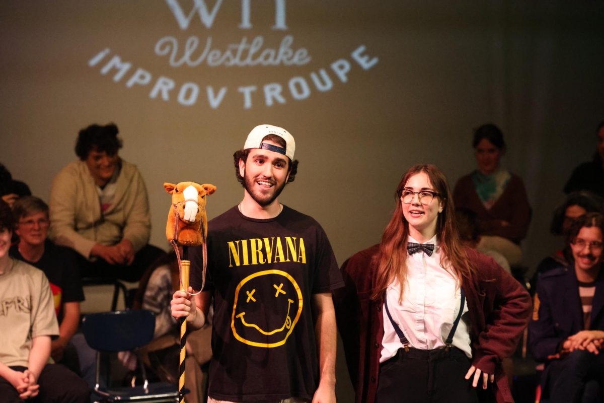 Seniors Calla Tucker and William Wilkes in the midst of acting out an improv scene.